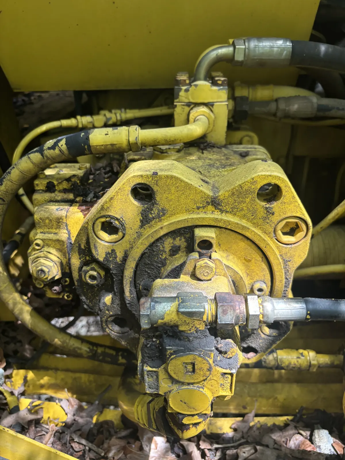 Hydraulic pump repair close-up on construction equipment
