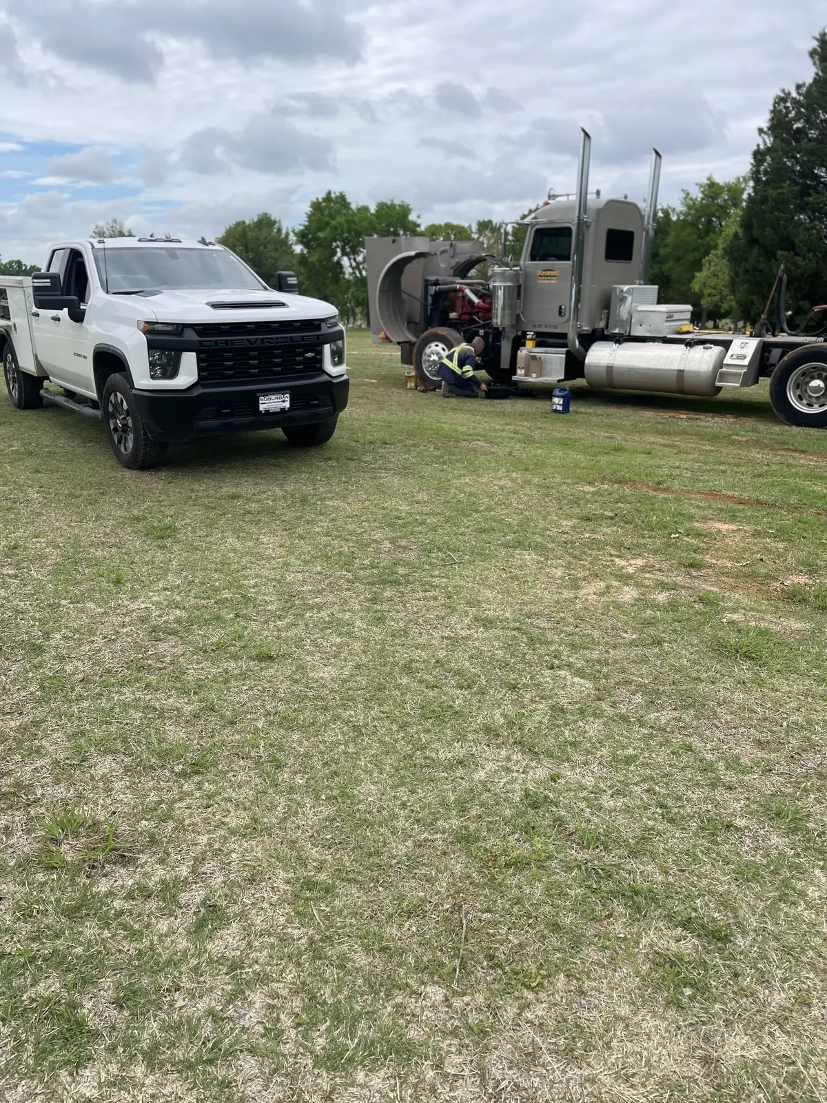 Fleet service truck and semi truck staged at a jobsite