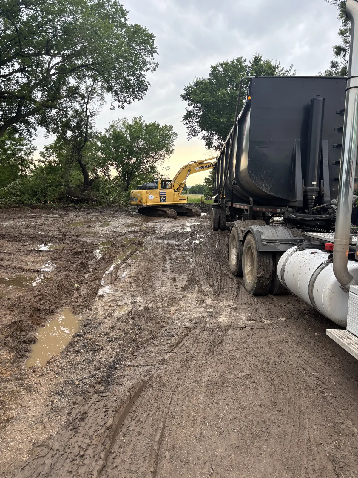 Emergency mobile recovery of a tanker truck stuck on a muddy jobsite