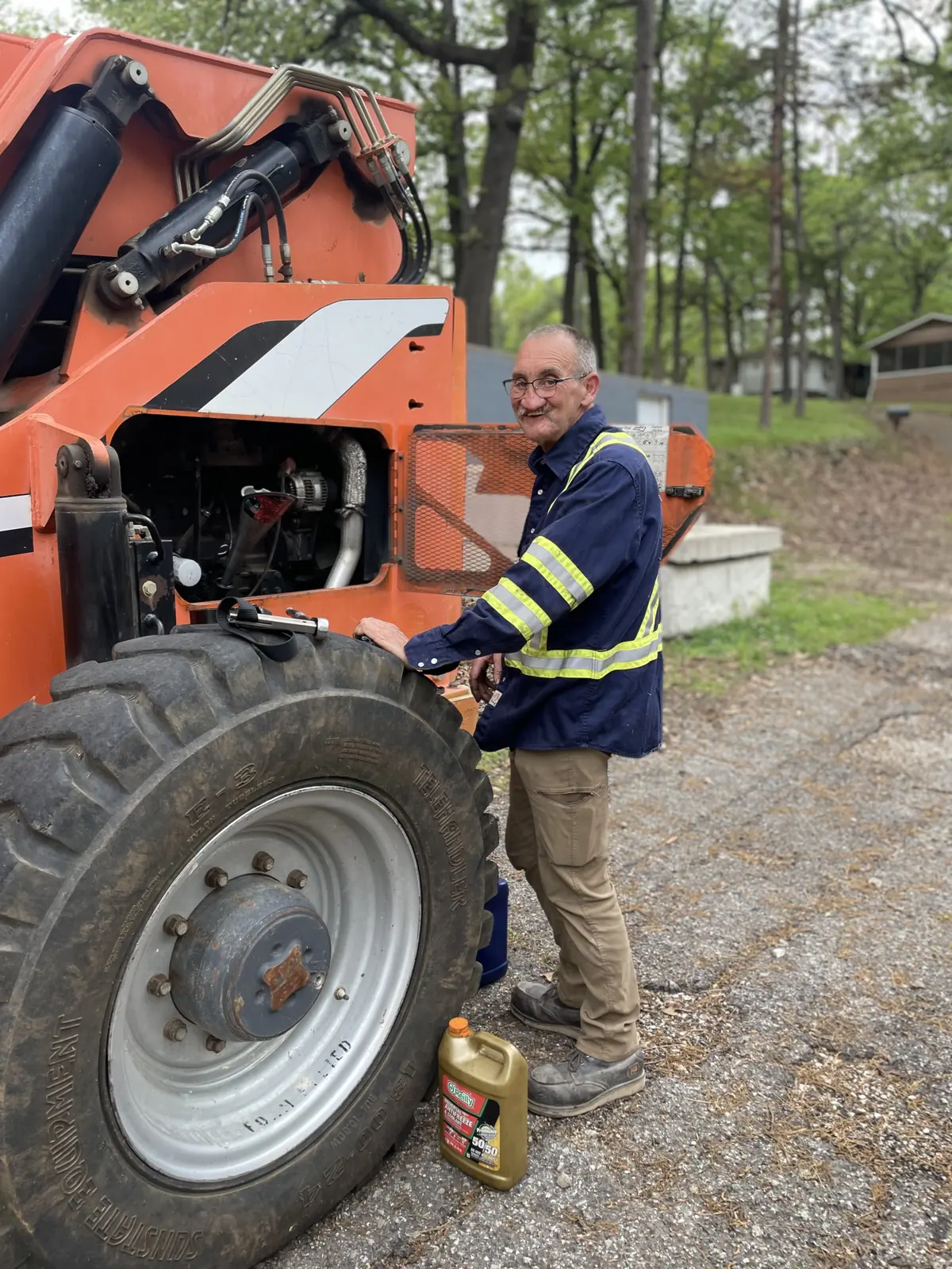 Tulsa Fleet Repair technician repairing a boom lift engine on-site