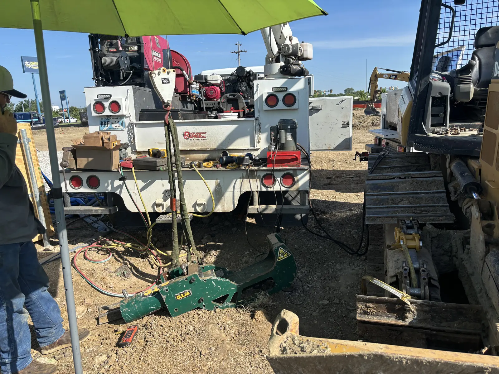Utility truck with crane extended for jobsite service