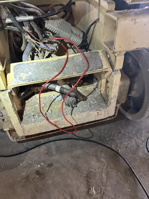 Battery compartment wiring repair on heavy equipment