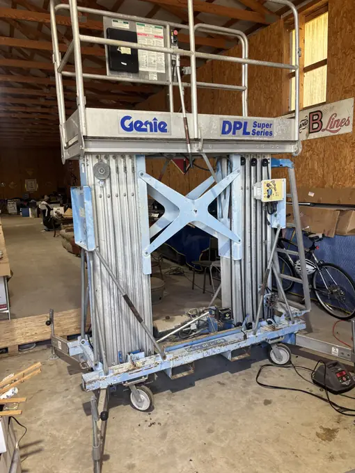 Genie personnel lift staged inside the repair shop