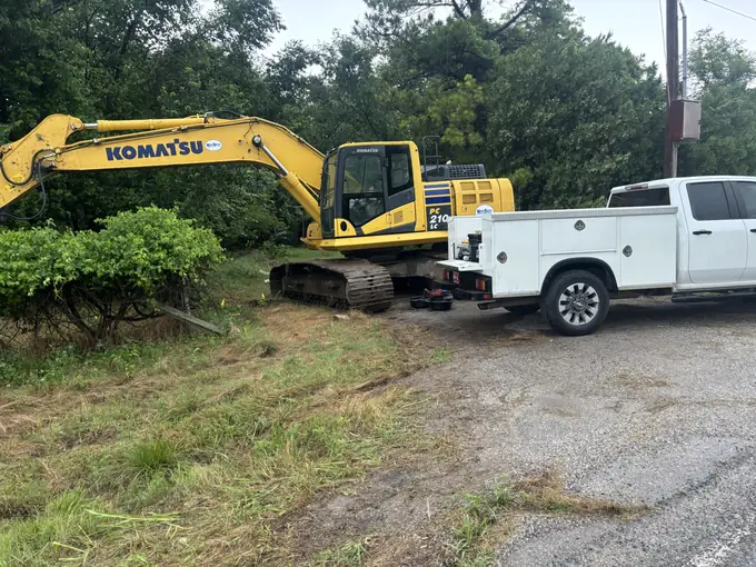 Komatsu excavator and mobile service truck on a repair call