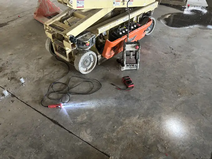 Mobile welding repair on a mini track loader in the shop