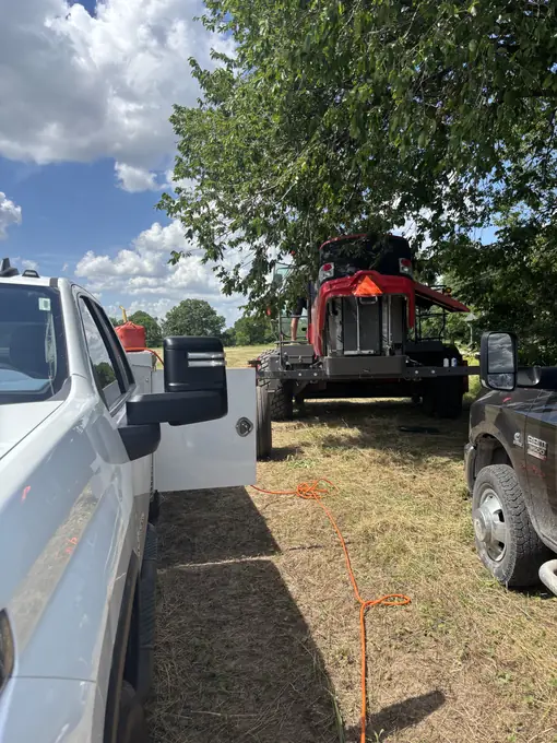 Service truck transporting a forestry mulcher after repair