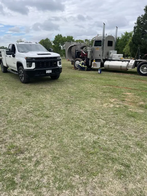 Fleet service truck and semi truck staged at a jobsite