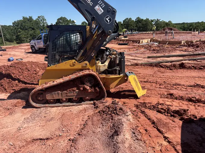 Skid steer loader repaired at a construction jobsite