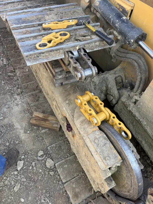 Track pad and grouser close-up during undercarriage repair