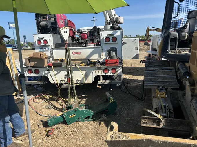 Utility truck with crane extended for jobsite service